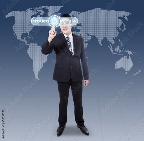 Photo: Businessman pressing digital button Businessman pressing digital button