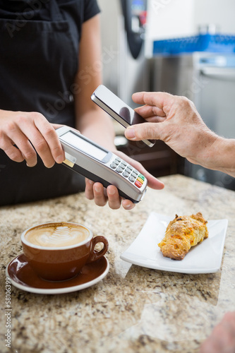 Photo: Customer Paying using NFC Customer Paying using NFC