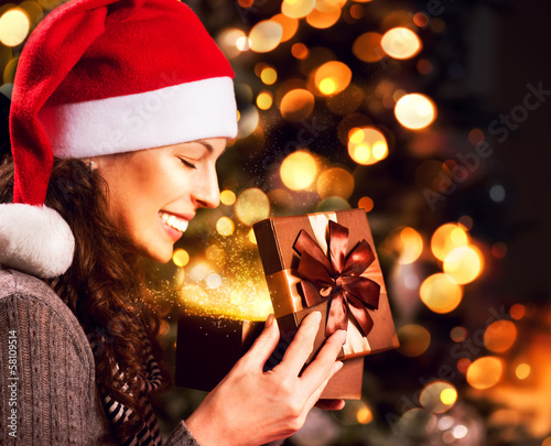 Photo: Christmas Gift. Happy Surprised Woman opening Giftbox Christmas Gift. Happy Surprised Woman opening Giftbox