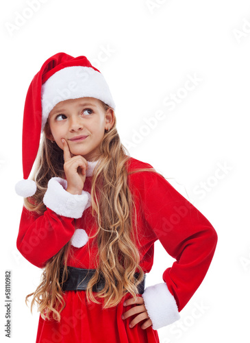 Photo: Thinking girl in christmas outfit Thinking girl in christmas outfit