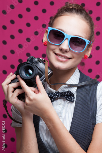Photo: Portrait of trendy smiling girl with retro camera Portrait of trendy smiling girl with retro camera