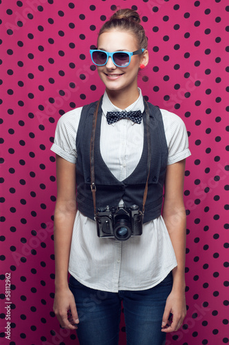 Photo: Hipster girl posing with vintage camera Hipster girl posing with vintage camera