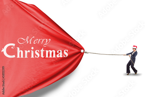 Photo: Businesswoman is pulling christmas banner isolated Businesswoman is pulling christmas banner isolated