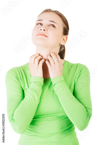 Photo: Attractive woman scratching her neck. Attractive woman scratching her neck.