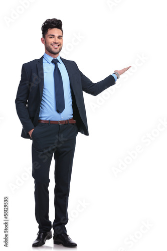 Photo: full body picture of a happy business man presenting full body picture of a happy business man presenting