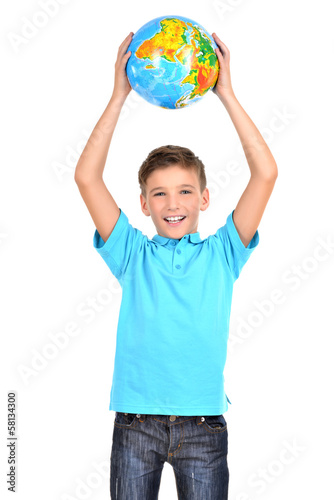 Photo: Smiling boy in casual holding globe in hands above his head Smiling boy in casual holding globe in hands above his head