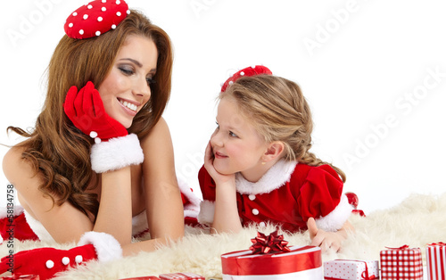 Photo: Beautiful woman and little girl dressed in costume santa claus Beautiful woman and little girl dressed in costume santa claus