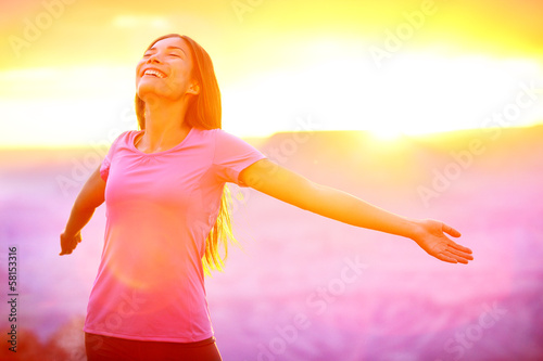 Photo: Happy people - free woman enjoying nature sunset Happy people - free woman enjoying nature sunset