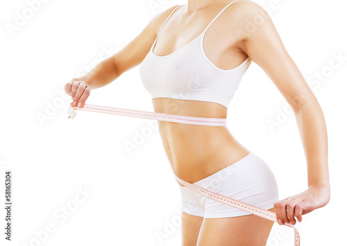 Photo: woman with measure on sporty body woman with measure on sporty body