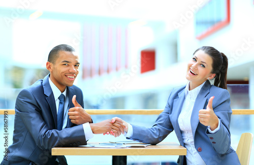 Photo: businessman shaking hands to seal a deal with his partner businessman shaking hands to seal a deal with his partner