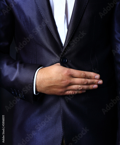 Photo: Close up of stylish man in elegant black suit Close up of stylish man in elegant black suit