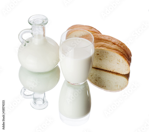 Photo: Glass and jug with milk on white background Glass and jug with milk on white background