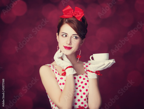 Photo: Beautiful redhead women with cup of tea. Beautiful redhead women with cup of tea.