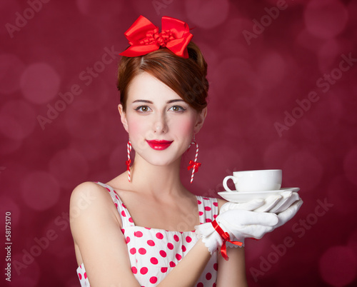 Photo: Beautiful redhead women with cup of tea. Beautiful redhead women with cup of tea.