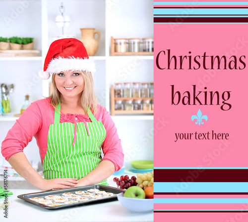 Photo: Woman in kitchen during cooking Christmas biscuits Woman in kitchen during cooking Christmas biscuits