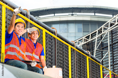 Photo: Asian technicians or workers on construction site Asian technicians or workers on construction site