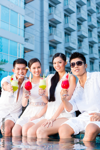 Photo: Chinese couples drinking cocktails in hotel pool bar Chinese couples drinking cocktails in hotel pool bar