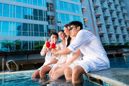 Photo: Chinese couples drinking cocktails in hotel pool bar Chinese couples drinking cocktails in hotel pool bar