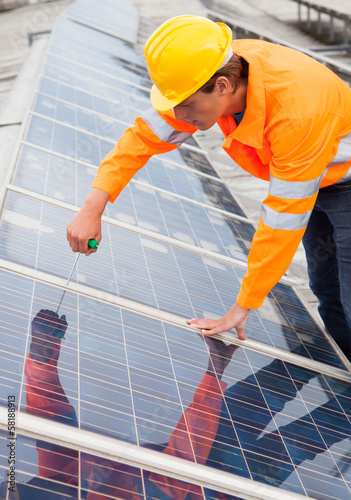 Photo: Engineer Adjusting Solar Panels Engineer Adjusting Solar Panels