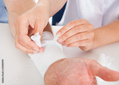 Photo: Doctor Bandaging Patient Doctor Bandaging Patient