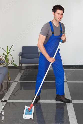 Photo: Man Cleaning The Floor Man Cleaning The Floor