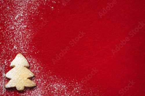 Photo: Christmas abstract background with cookies on red fabric Christmas abstract background with cookies on red fabric