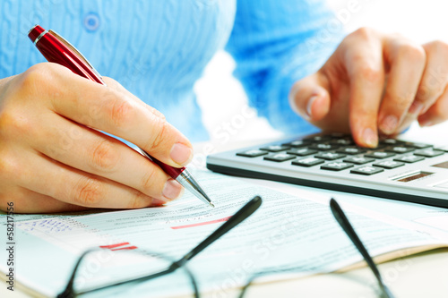 Photo: Hands with calculator. Hands with calculator.