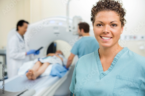 Photo: Nurse With Colleague And Doctor Preparing Patient For CT Scan Nurse With Colleague And Doctor Preparing Patient For CT Scan