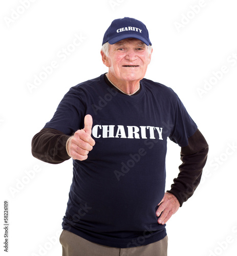 Photo: elderly charity volunteer giving thumb up elderly charity volunteer giving thumb up