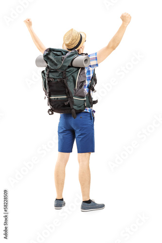 Photo: Full length portrait of a male hiker with raised hands gesturing Full length portrait of a male hiker with raised hands gesturing