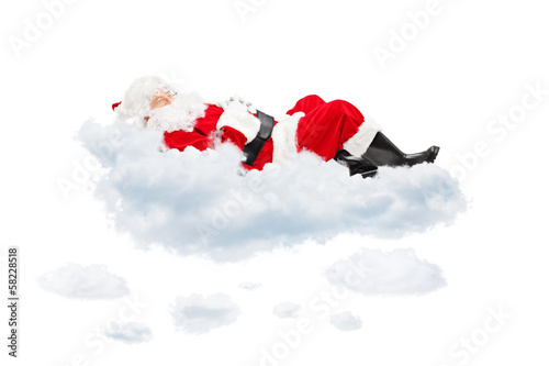 Photo: Santa Claus resting while lying on cloud Santa Claus resting while lying on cloud