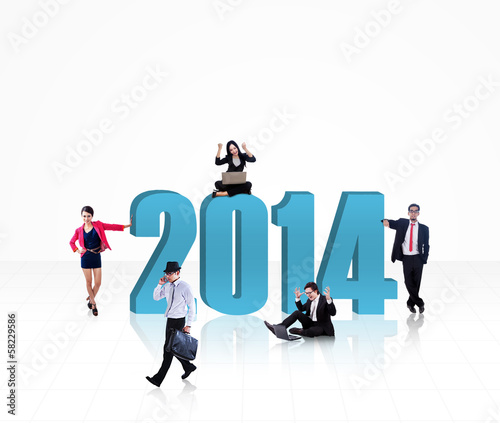 Photo: Business team with the new year 2014 - isolated Business team with the new year 2014 - isolated