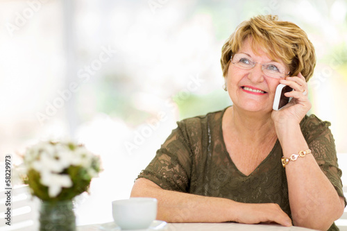 Photo: senior woman talking on her cell phone senior woman talking on her cell phone