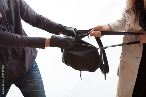 Photo: Thief trying to snatch a backpack Thief trying to snatch a backpack