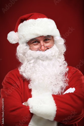 Photo: Photo of happy Santa Claus in eyeglasses looking at camera Photo of happy Santa Claus in eyeglasses looking at camera