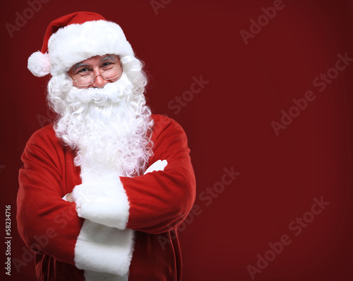 Photo: Photo of happy Santa Claus in eyeglasses looking at camera Photo of happy Santa Claus in eyeglasses looking at camera