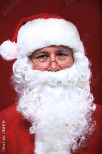Photo: Photo of happy Santa Claus in eyeglasses looking at camera Photo of happy Santa Claus in eyeglasses looking at camera