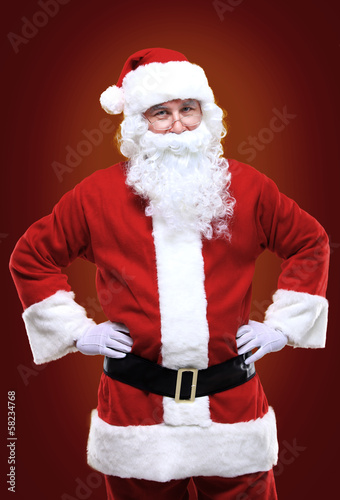 Photo: Photo of happy Santa Claus in eyeglasses looking at camera Photo of happy Santa Claus in eyeglasses looking at camera