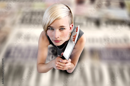 Photo: Woman with knife on newspapers Woman with knife on newspapers