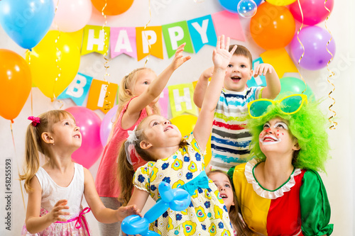 Photo: jolly kids group with clown celebrating birthday party jolly kids group with clown celebrating birthday party