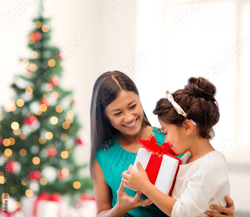 Photo: happy mother and child girl with gift box happy mother and child girl with gift box