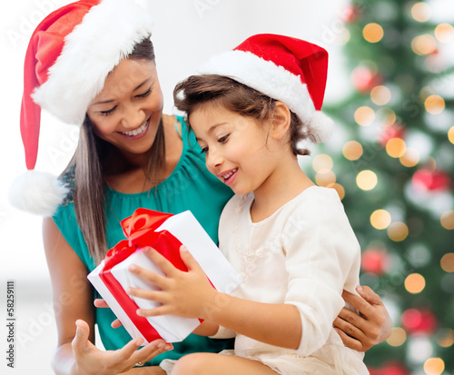 Photo: happy mother and child girl with gift box happy mother and child girl with gift box