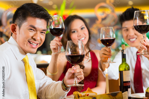 Photo: Chinese couples toasting with wine in restaurant Chinese couples toasting with wine in restaurant