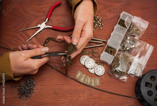 Photo: hands making craft jewellery hands making craft jewellery