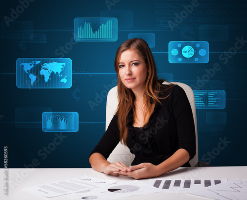 Photo: Businesswoman doing paperwork with digital background Businesswoman doing paperwork with digital background