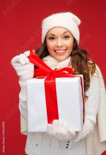 Photo: smiling woman in white clothes with gift box smiling woman in white clothes with gift box