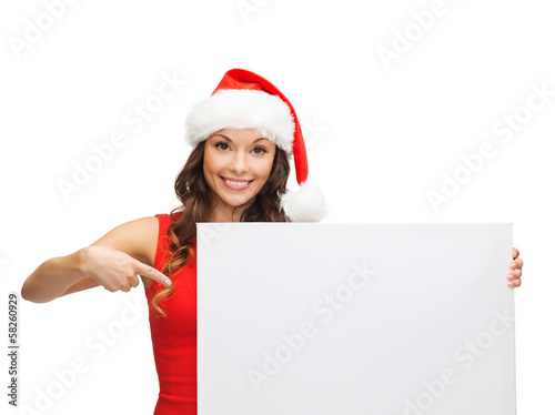 Photo: woman in santa helper hat with blank white board woman in santa helper hat with blank white board
