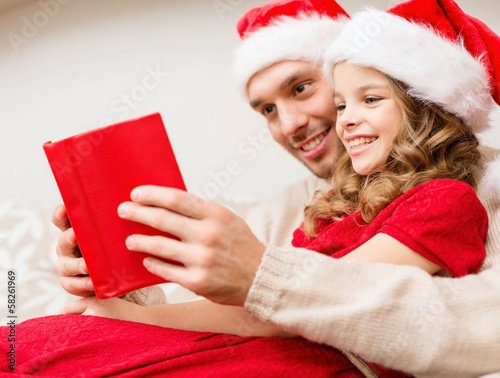 Photo: smiling father and daughter reading book smiling father and daughter reading book