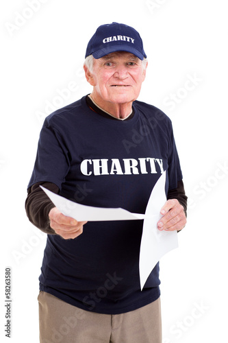 Photo: senior charity worker handing out papers senior charity worker handing out papers