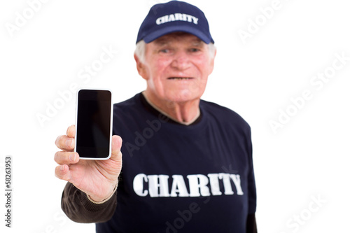 Photo: elderly charity volunteer showing smart phone elderly charity volunteer showing smart phone